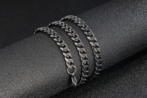 Close-up of vintage black 304 stainless steel Cuban chain with textured clasp detail