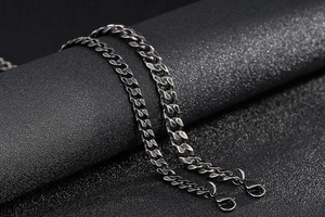 Detail of black stainless steel Cuban link necklace with secure lobster clasp closure