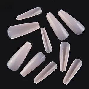 Detailed view of ten translucent coffin press-on nail tips with size numbers on black backdrop