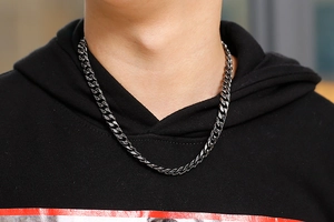Close-up of vintage gunmetal 304 stainless steel curb chain necklace worn by male model