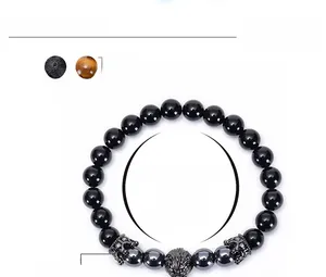 Detailed view of 8mm lava stone and chakra beads bracelet with wolf and crown charms