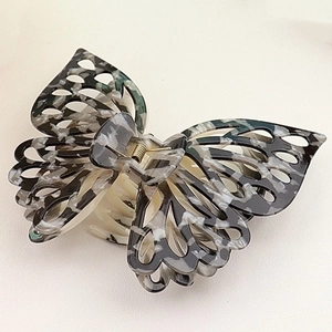 Detail of 14cm double butterfly claw clip with grey marble pattern and metal spring
