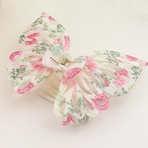 Detail view of 14cm butterfly hair claw clip with pink floral patterns and hollow design