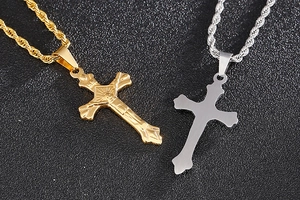 Detail of silver and gold stainless steel cross pendants with twisted rope chains