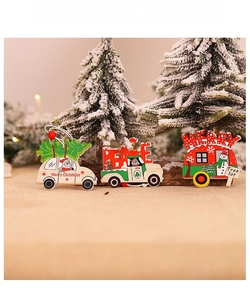 Detail of wooden Christmas tree ornaments featuring cartoon cars on burlap background