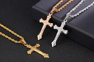 Three stainless steel cross pendants with rope chains in gold, rose gold and silver finishes