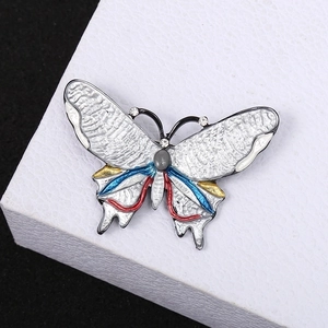 Enamel butterfly brooch with colorful crystals and pearl on a premium display stand