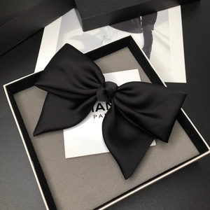 Large black satin bow hair clip in a premium gift box with an elegant minimalist design