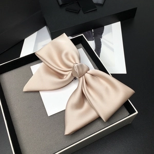 Elegant champagne satin oversized bow hair clip presented in a premium gift box