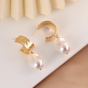 French vintage gold C-shape earrings featuring textured water ripples and baroque pearls