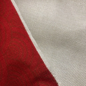 Macro shot of red patterned fabric and beige mesh linen with durable white piping detail