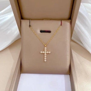 Titanium steel cross necklace with crystal pavé pendant in a brown jewelry box