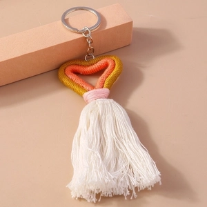 Close-up of pink, orange, and yellow knit heart keychain with long white tassels
