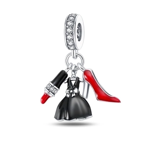 Detail of silver charms featuring a black dress, red high heel, and lipstick