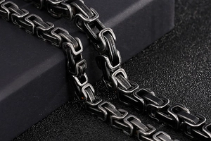 Macro shot of men's vintage byzantine stainless steel chain bracelet with oxidized finish