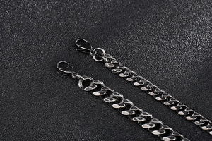 Macro detail of gunmetal curb chain with vintage finish and lobster clasp closure