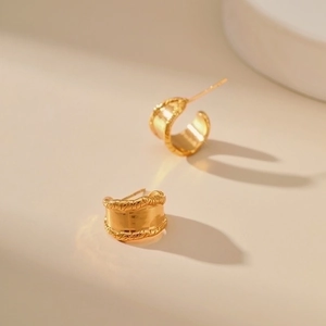 Golden chunky hoop earrings with woven texture and irregular minimalist design