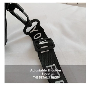 Detail of adjustable black nylon shoulder strap with white YOUNG lettering and plastic hook