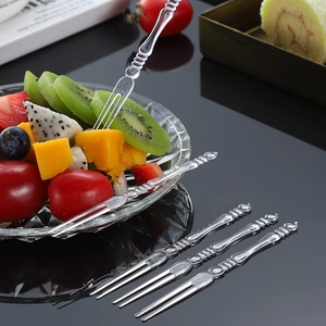 Transparent disposable fruit forks with beaded handles for snacks and dessert cakes