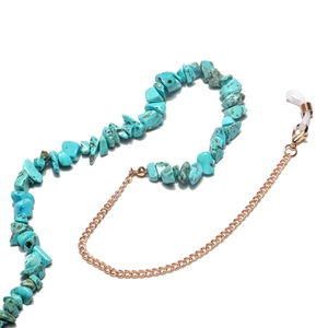 Detail of natural blue turquoise stone chain with gold metal link and rubber loop fasteners