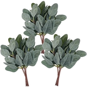 Detailed macro view of three artificial eucalyptus stems with frosted green leaves