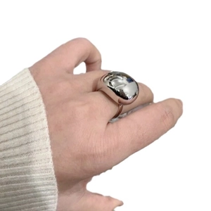 Polished silver water drop ring in minimalist organic design on female finger