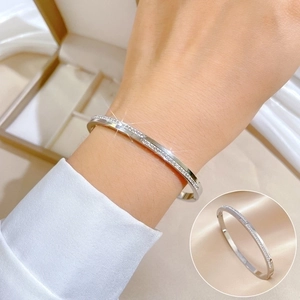 Minimalist silver stainless steel bangle featuring full row of sparkling zircon stones