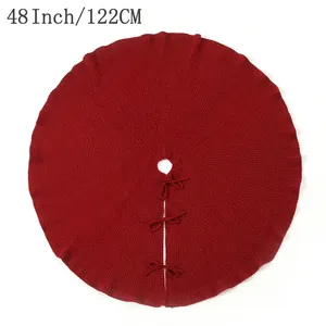 Classic 48-inch red knitted Christmas tree skirt with bow ties on white background