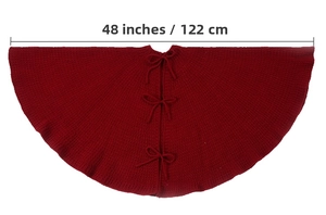 Detail of 48-inch deep red knitted Christmas tree skirt with decorative bow ties