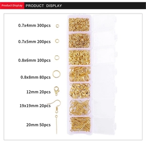 Macro view of gold jewelry making kit with lobster clasps and open rings in 7-grid box