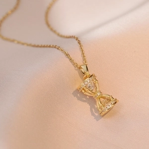 Exquisite hourglass pendant necklace in gold finish with micro-pave cubic zirconia accents