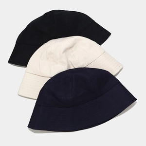 Minimalist cotton bucket hats in black, off-white, and navy blue with reinforced stitching