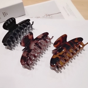 Large leopard print hair claw clips in black and amber tortoise patterns for women