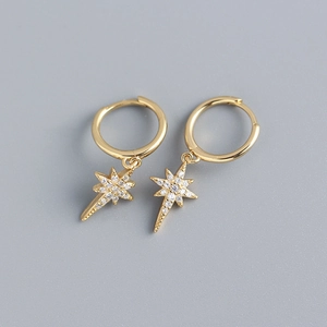 Detailed macro view of S925 sterling silver gold hoop earrings with sparkling star pendants
