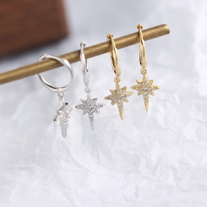 Detail view of S925 sterling silver star stud earrings in gold and silver finish with diamonds