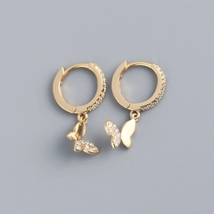 Detailed macro view of S925 silver gold butterfly earrings with cubic zirconia inlay