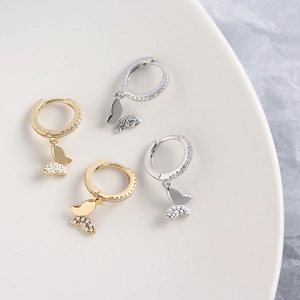 Close-up of gold and silver S925 sterling silver butterfly hoop earrings with pavé zircons