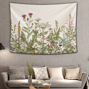 Detail of floral tapestry hanging above grey sofa in a cozy interior living room setup