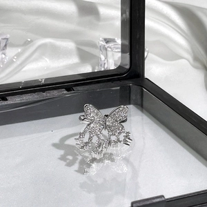Macro shot of silver butterfly ring with sparkling zircons in a premium black display box