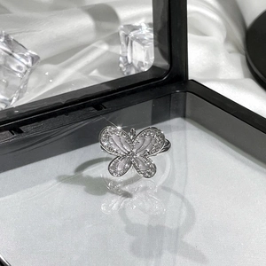 Detailed view of butterfly ring with shimmering opal wings and micro-pave zirconia crystals