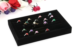 Five-row black velvet ring display tray filled with twenty colorful gemstone rings