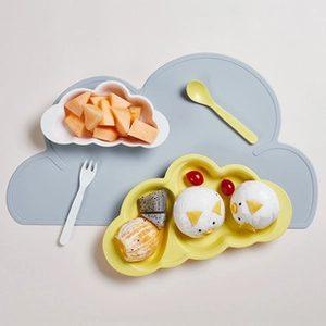 Flat lay of bamboo fiber kids tableware set with cloud shaped plate and baby cutlery
