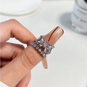 Silver bow ring with pink gemstone and zircon band set, stacked for a minimalist look