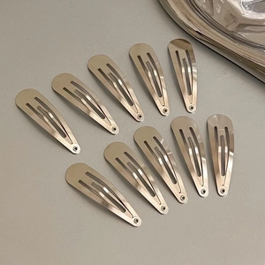 Macro shot of 10-piece set silver metal teardrop BB hair clips arranged in a fan shape