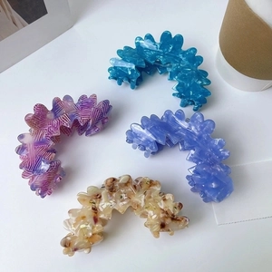 Set of four wavy cloud acetate hair claws in blue, purple, and patterned beige