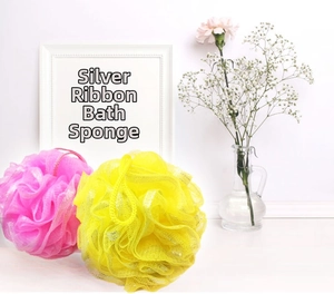 Detailed close-up of soft bath sponges with fine mesh, silver ribbons and hanging ropes