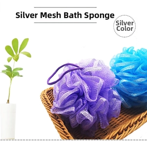 Close-up of blue and purple mesh bath sponges with silver glitter thread in a basket