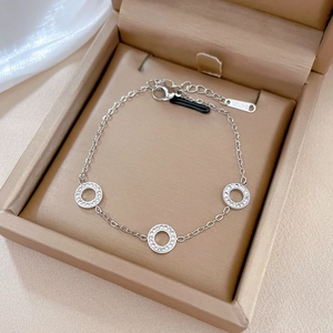 Macro detail of silver stainless steel bracelet with zircon circles in a jewelry box