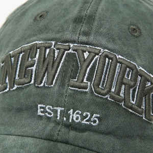 Detailed close-up of 3D New York embroidery and vintage washed cotton baseball cap texture