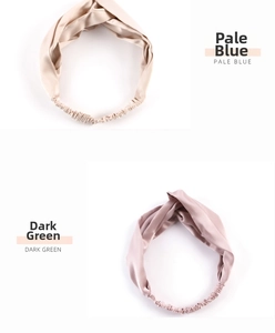 Detail of twisted silk headbands in apricot and mauve colors with elastic back